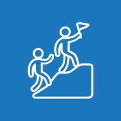 two people scaling hill with flag