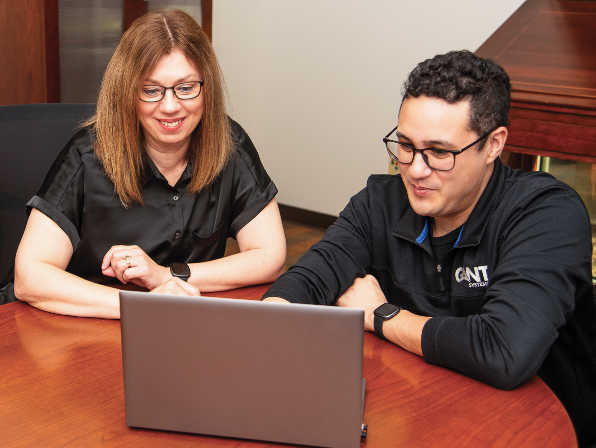 Gant employees looking at laptop troubleshooting IT